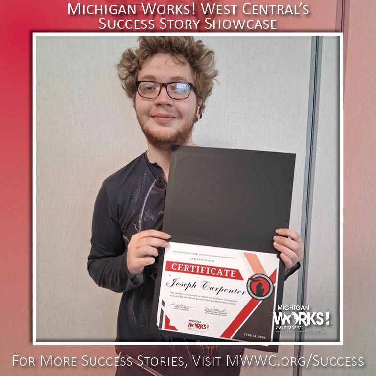 Person holding a certificate and black folder in front of a “Michigan Works! West Central” success story backdrop.