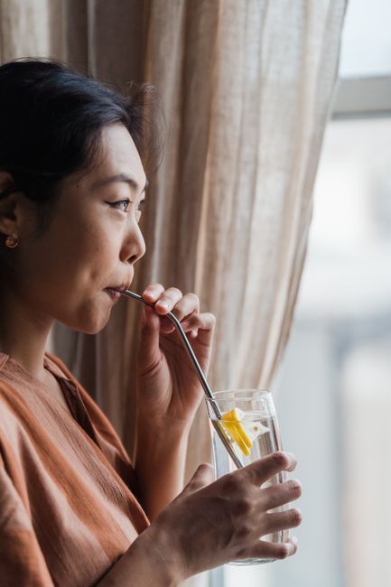 Woman drinking water to help prevent recurrent UTIs, advice from Hommage Women's Clinic, Gangnam, Seoul