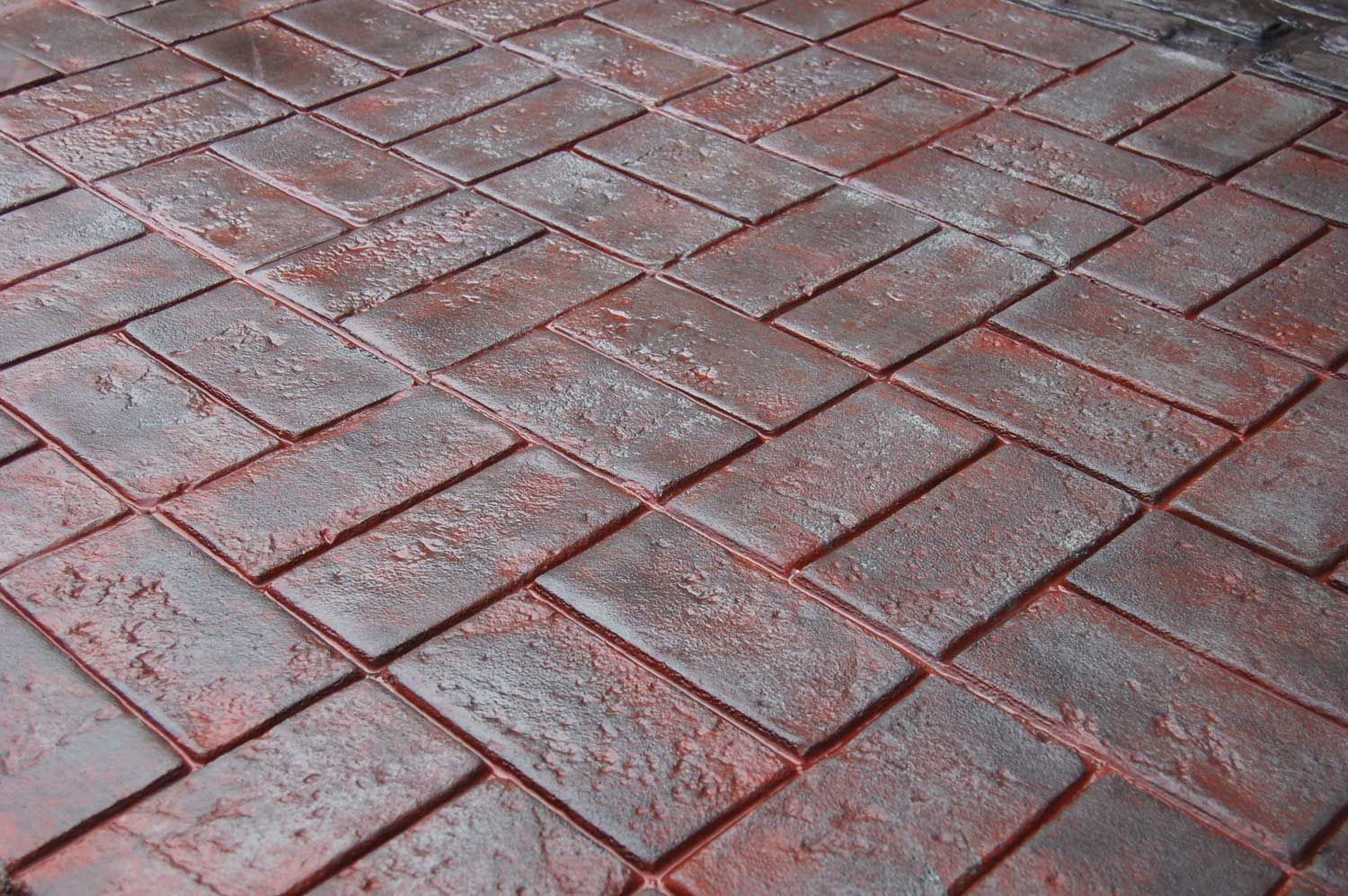 Basket Weave Brick stamped concrete with a red brick pattern and realistic textured finish.