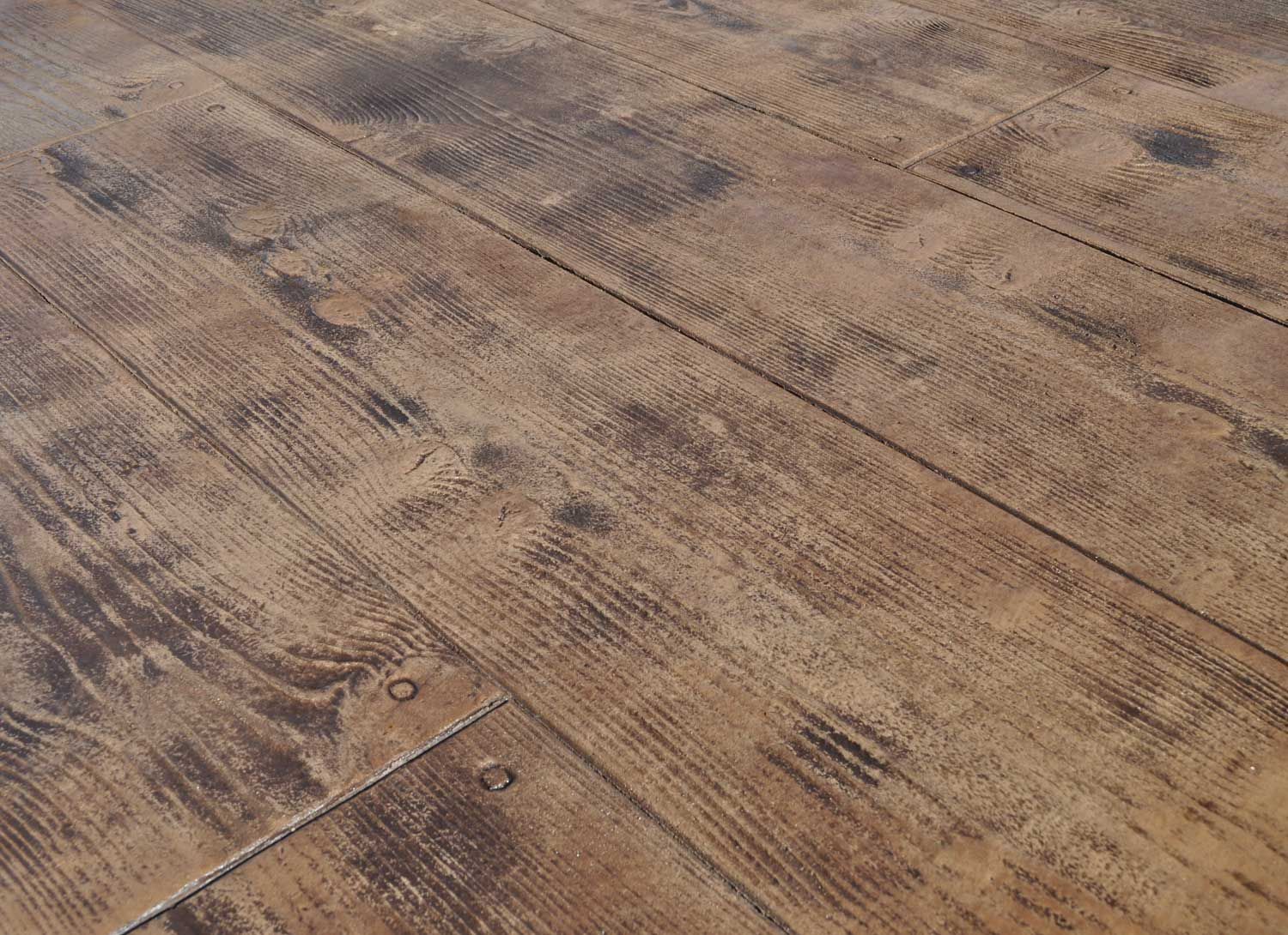 12-inch Cedar Plank stamped concrete with realistic wood grain, knots, and rustic texture.