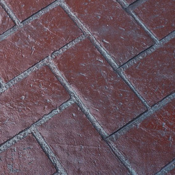 New Herringbone Brick stamped concrete with a red brick pattern and realistic textured finish.