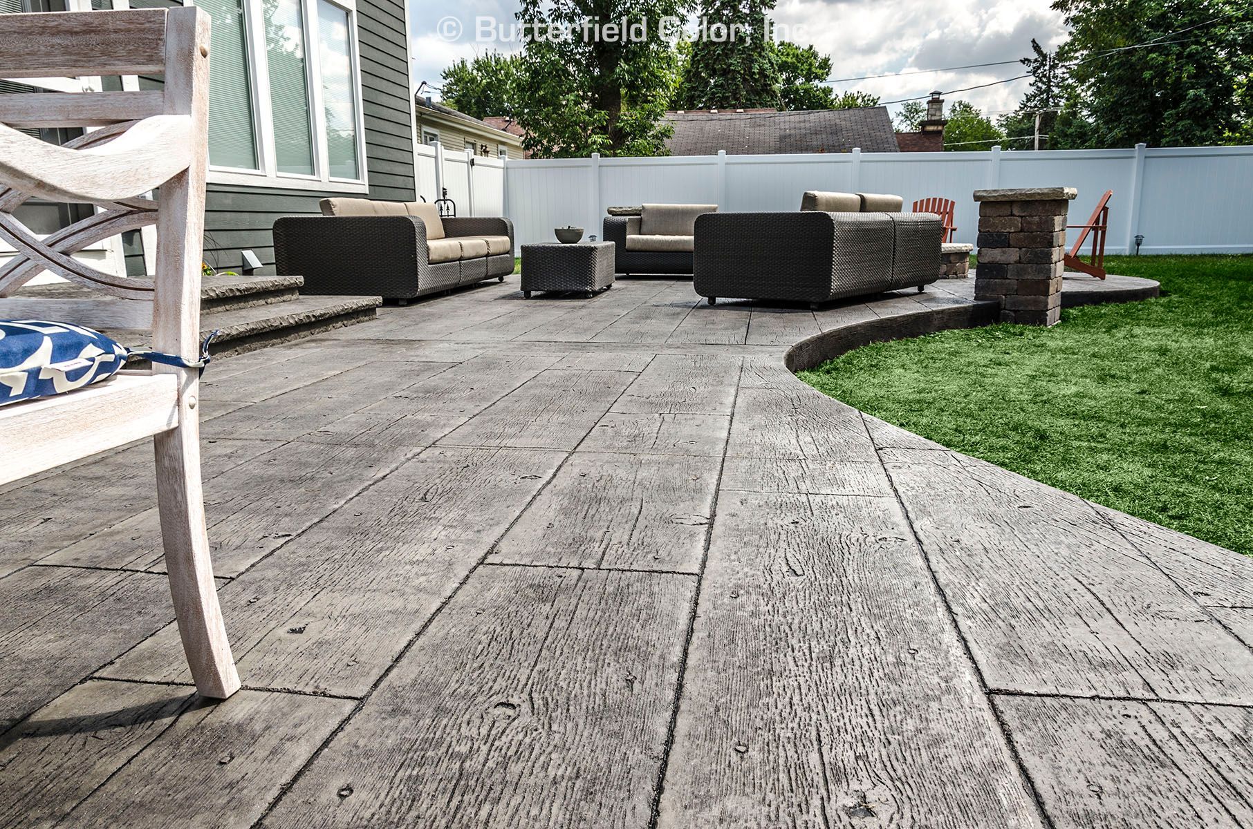 Gilpin’s Fall Bridge Plank stamped concrete patio with realistic wood-grain texture.