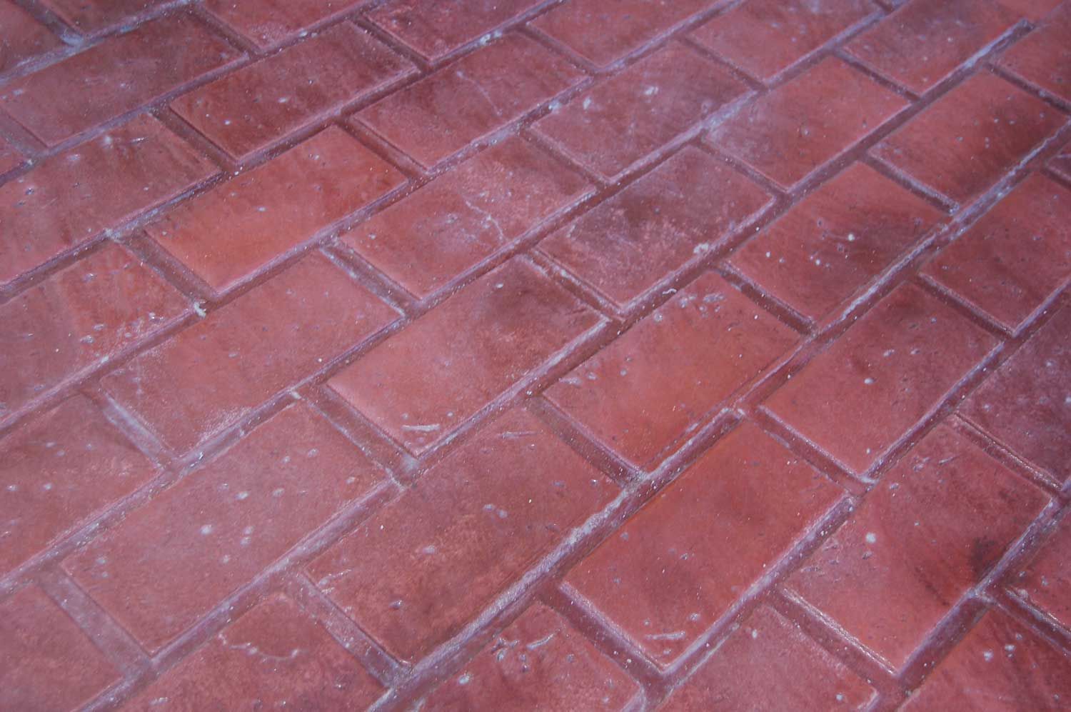 Running Red Brick stamped concrete with a classic brick layout and lightly textured finish.