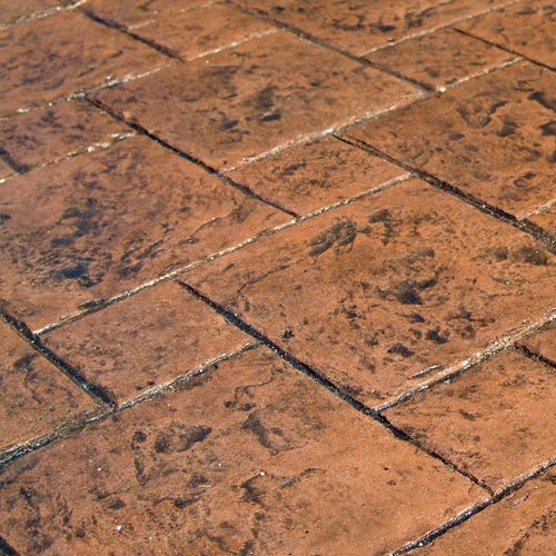 Terra Stone stamped concrete with warm earth tones and a textured rectangular stone pattern.
