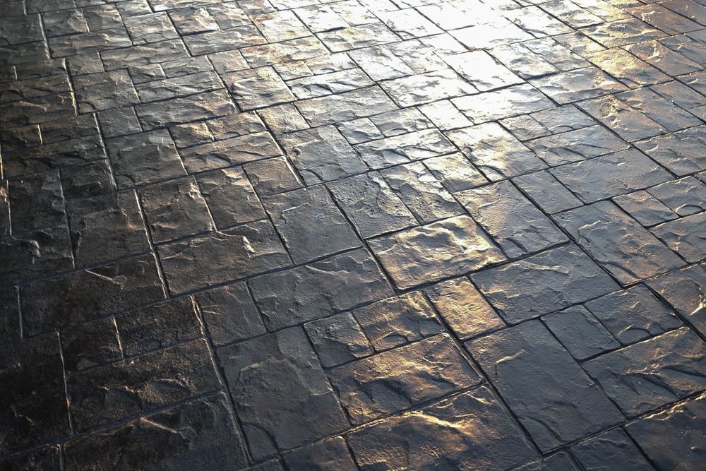 Stamped decorative concrete surface with natural stone pattern, ideal for patios, walkways, and outdoor living spaces