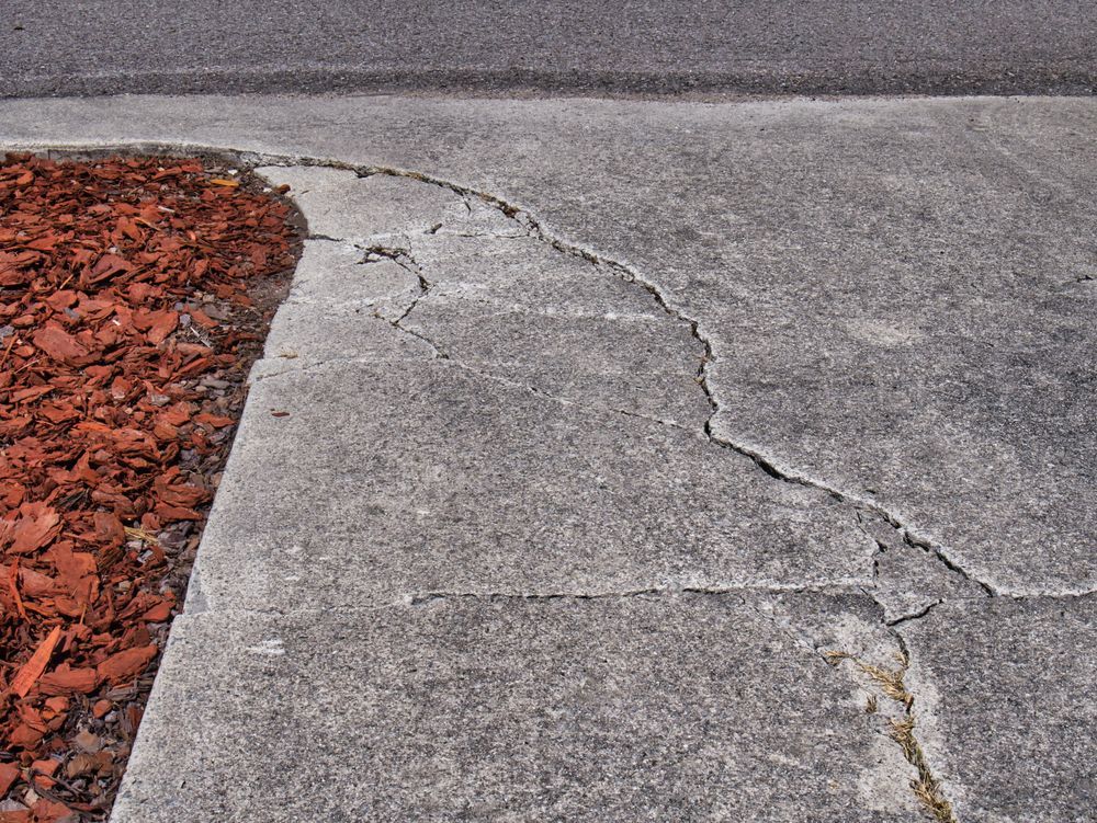 A cracked concrete driveway.