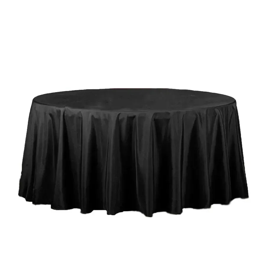 A round table covered with a plain white tablecloth against a white background.