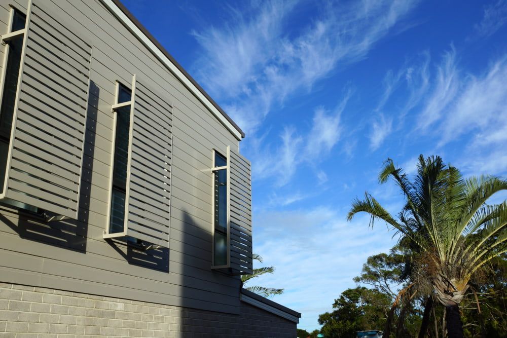 Gray Building With Louvres In Windows — A & B Lattice World & Patios in Bungalow, QLD