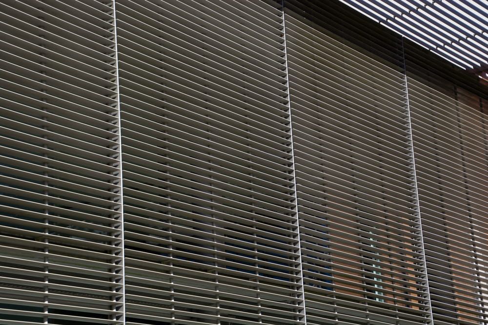Metallic Horizontal Louvres Covering a Building Facade — A & B Lattice World & Patios in Bungalow, QLD