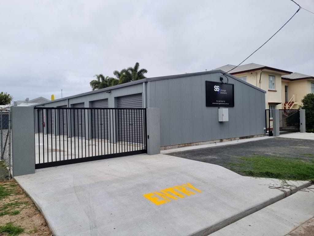 Gated Driveway and Single-story Building With a Black Sign — A & B Lattice World & Patios In Tablelands, QLD