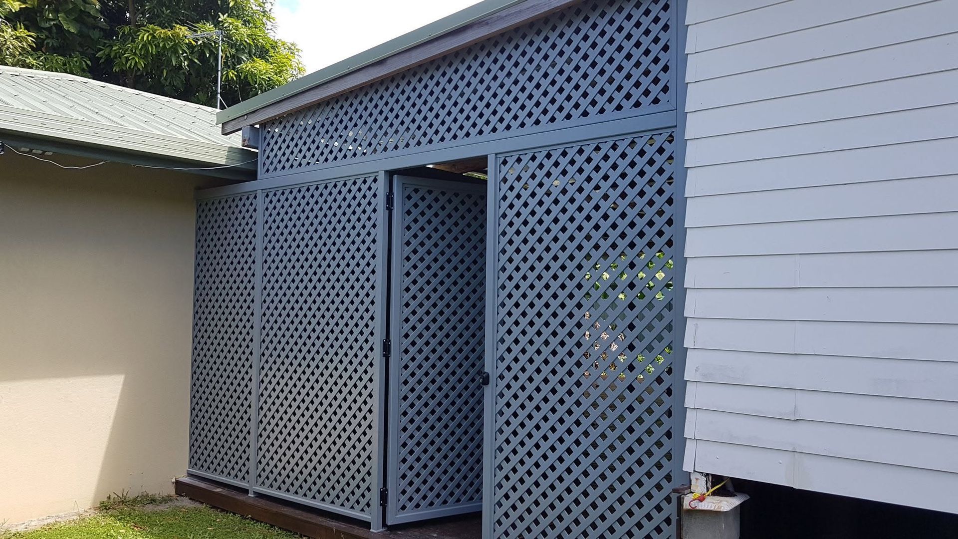 Blue-grey Lattice Screen Enclosing a Small Doorway — A & B Lattice World & Patios in Northern Beaches, QLD