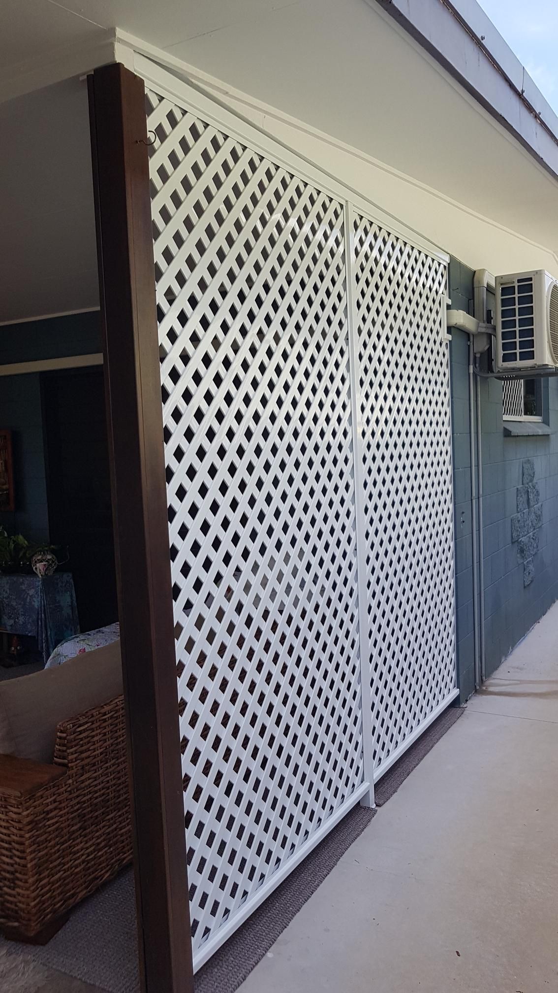 A Window with A Fence Around It Is on A White Wall — A & B Lattice World & Patios in Bungalow, QLD