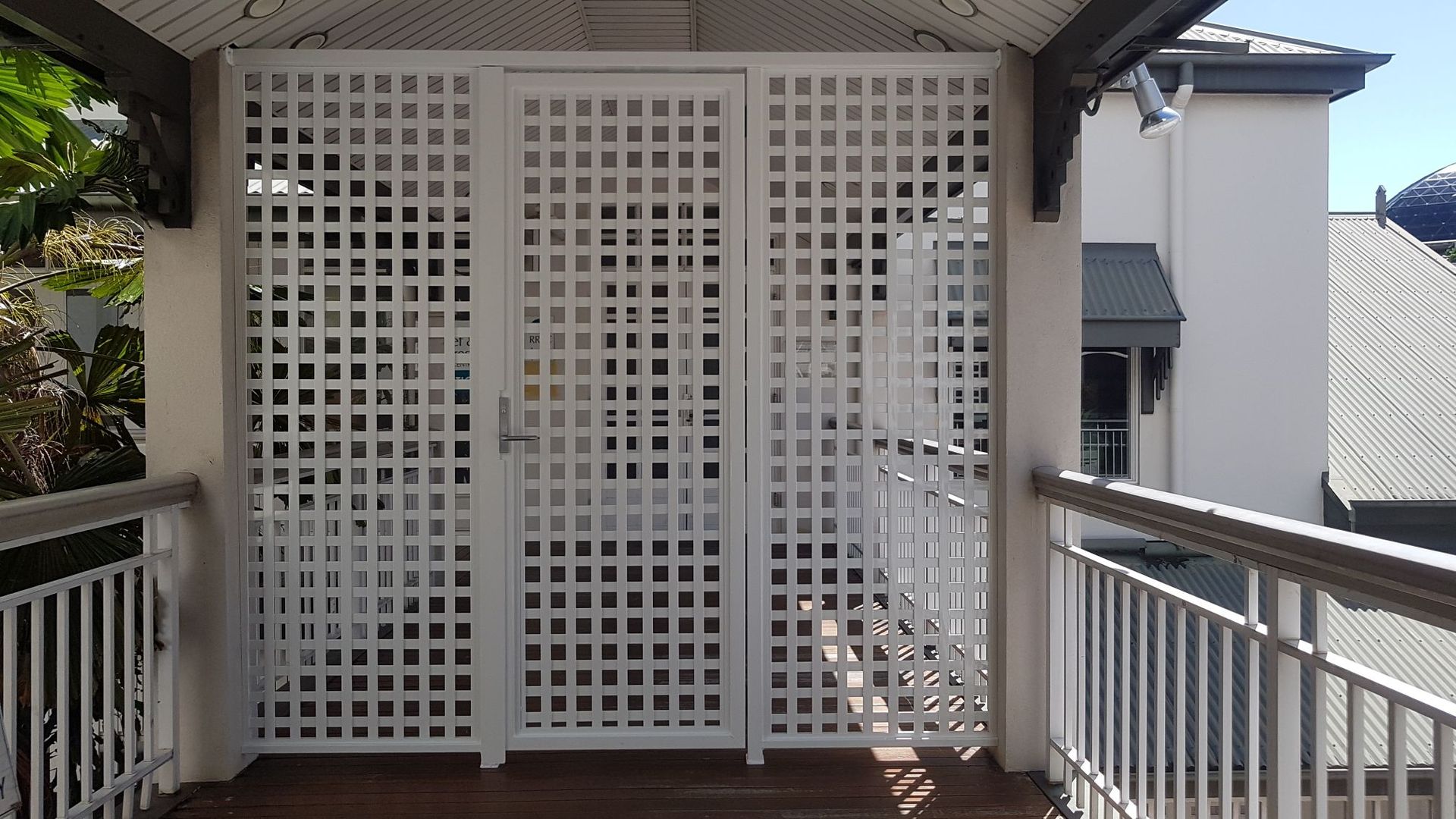 A Fence Is Sitting in Front of A House with A Sliding Glass Door — A & B Lattice World & Patios in Bungalow, QLD