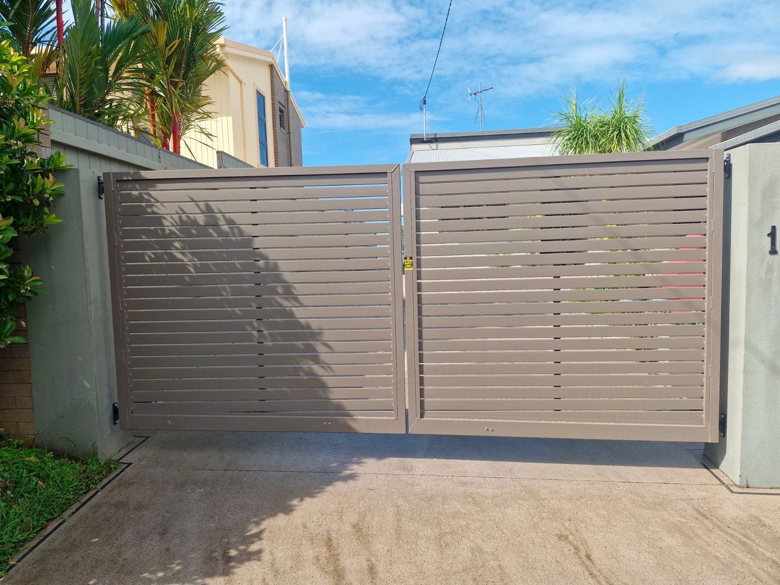 A Fence Is Sitting in Front of A House with A Sliding Glass Door — A & B Lattice World & Patios in Bungalow, QLD