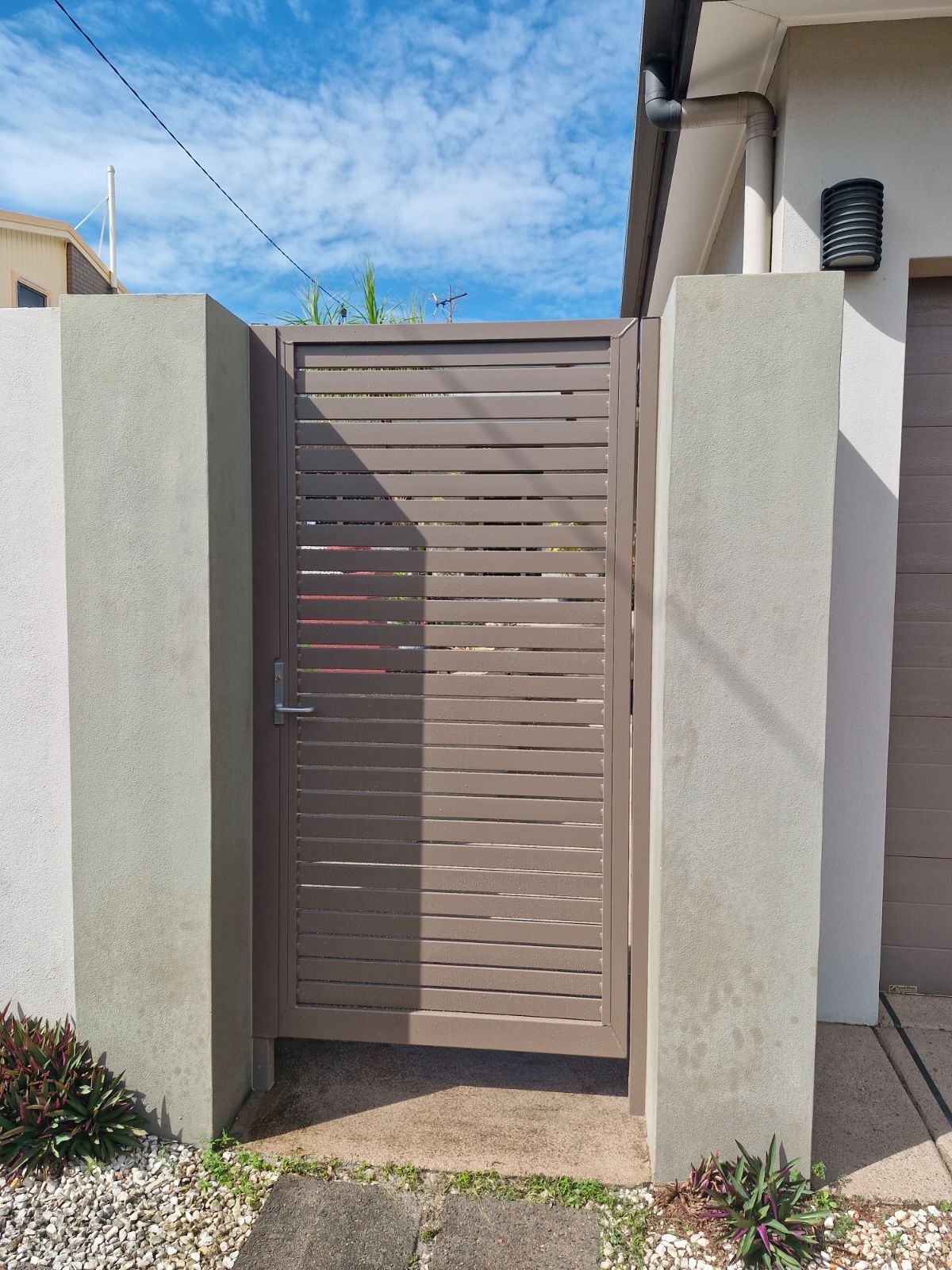A Brown Gate made of Aluminium — A & B Lattice World & Patios in Bungalow, QLD