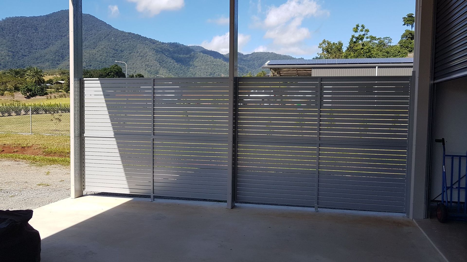 A Building with A Fence in Front of It and A Sliding Glass Door — A & B Lattice World & Patios in Bungalow, QLD