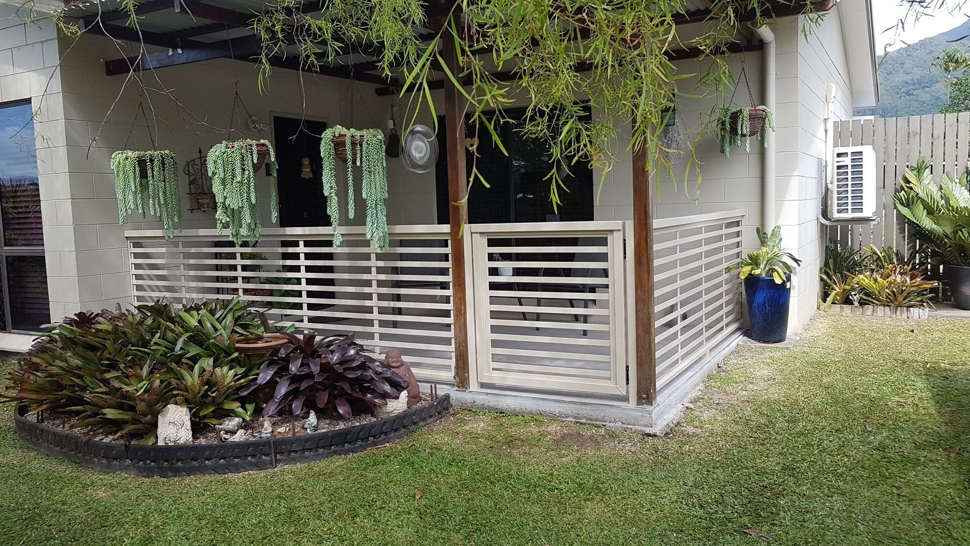 A Brick House with A Wooden Lattice on The Side of It — A & B Lattice World & Patios in Bungalow, QLD