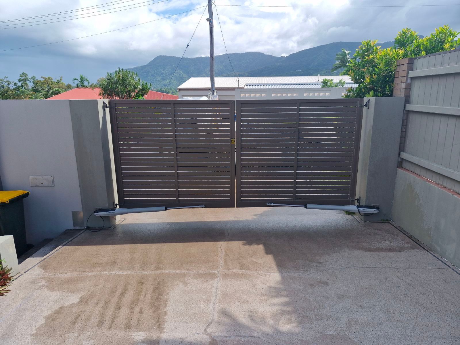 A Wooden Fence Is Sitting on Top of A Concrete Driveway — A & B Lattice World & Patios in Bungalow, QLD