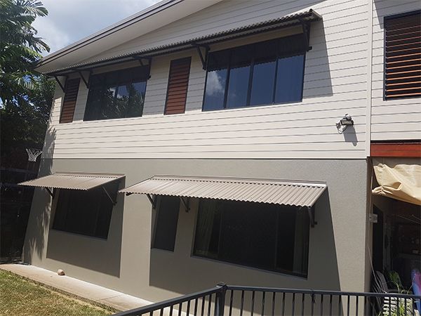 A Large House with A Lot of Windows and A Fence in Front of It — A & B Lattice World & Patios in Bungalow, QLD