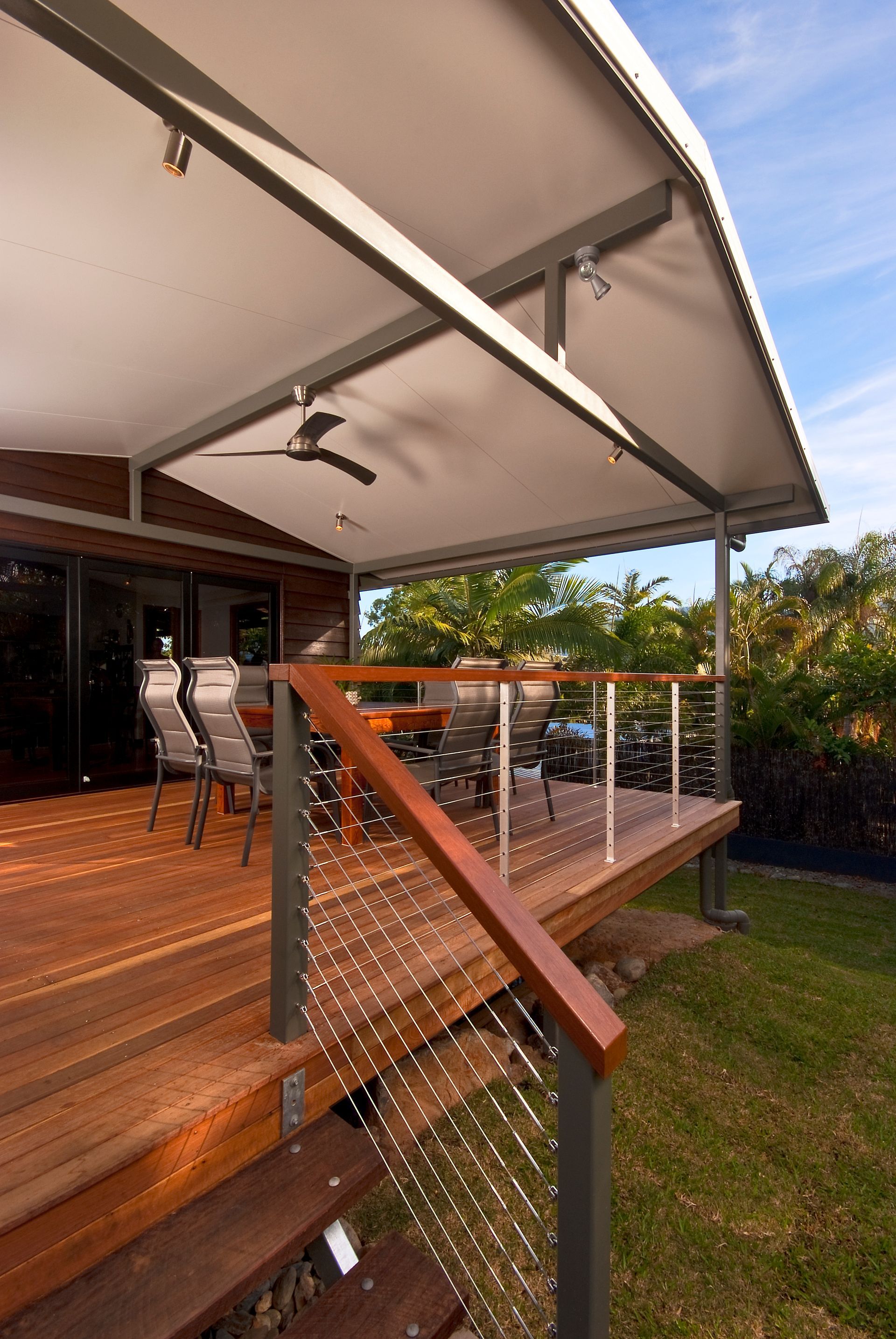A Wooden Deck with Chairs — A & B Lattice World & Patios in Bungalow, QLD