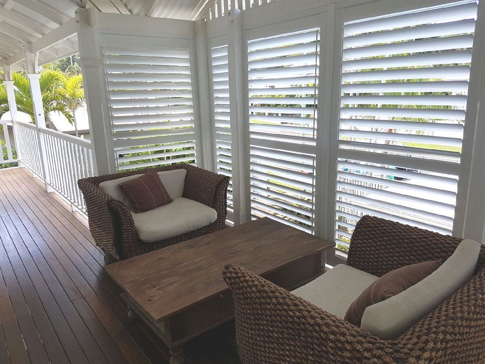 A Patio with A Hammock and A Potted Plant in Front of A House — A & B Lattice World & Patios in Bungalow, QLD