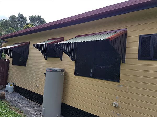 A House with A Water Heater on The Side of It — A & B Lattice World & Patios in Northern Beaches, QLD