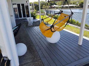 A Yellow Hammock Is Hanging on A Wooden Deck  — A & B Lattice World & Patios in Bungalow, QLD