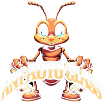 Cartoon orange ant mascot holding a white banner, smiling with large blue eyes.