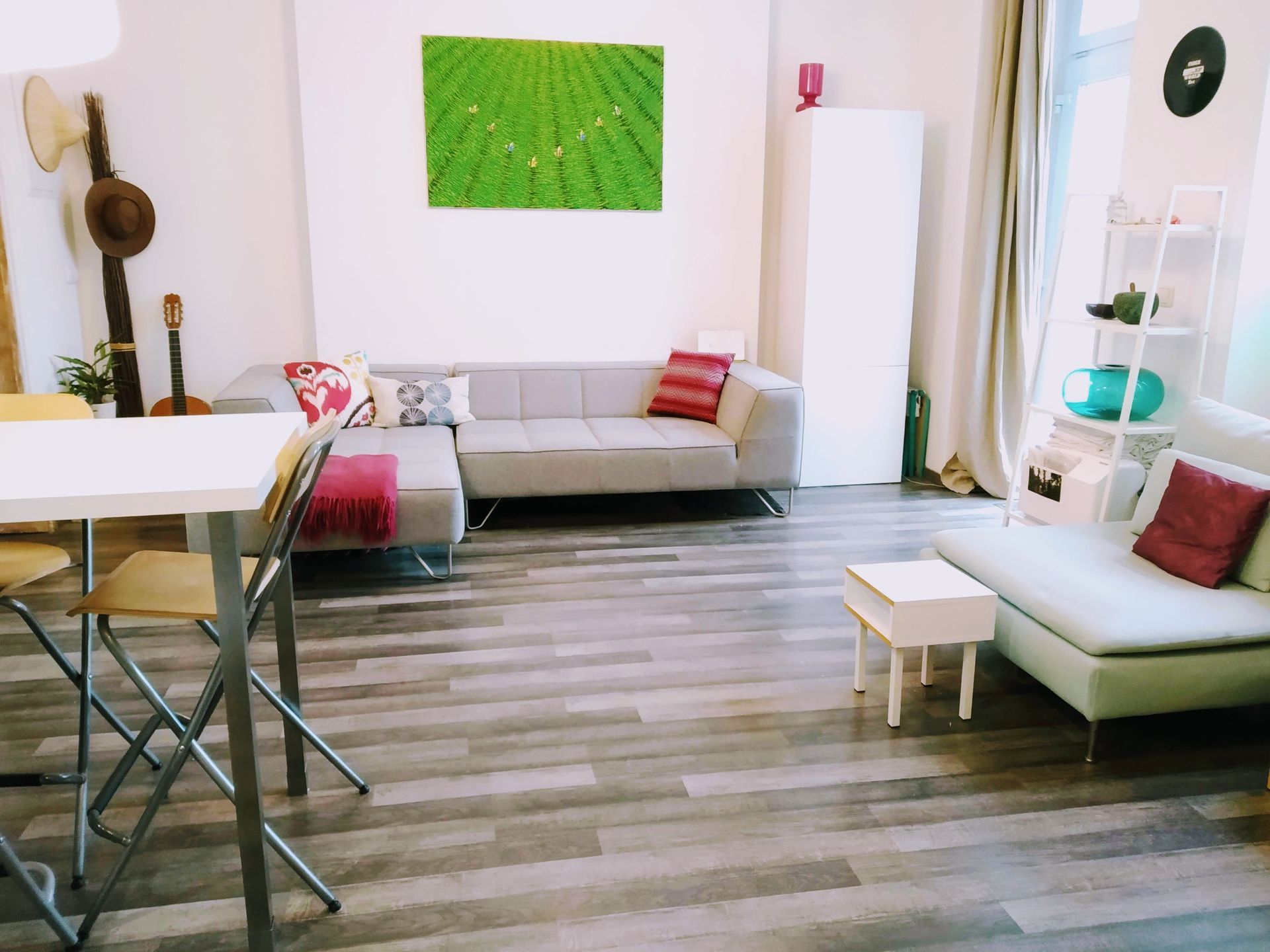 A living room of our holiday apartment in Berlin with a couch , table and chairs