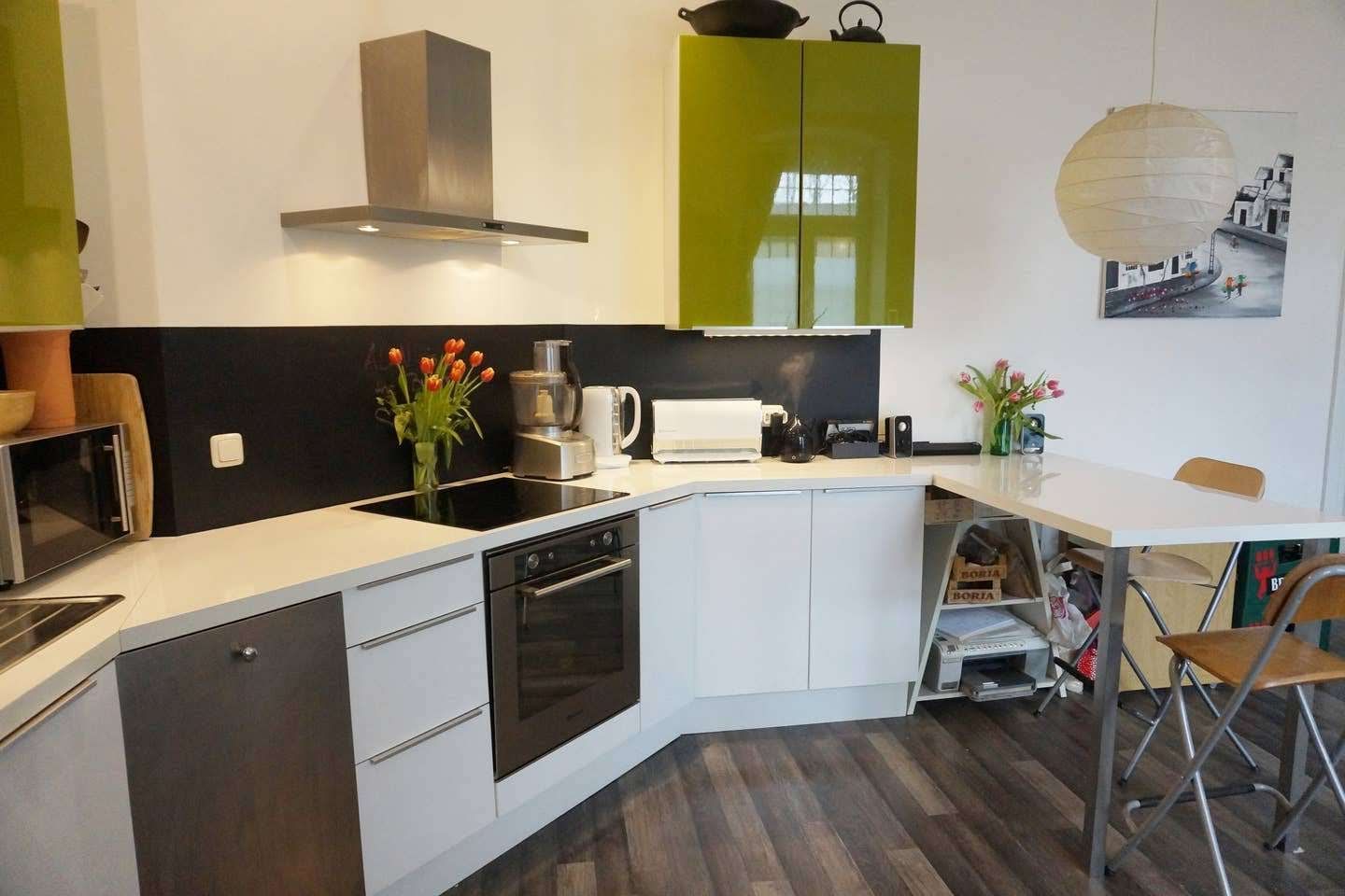 A kitchen of our holiday renal in Berlin with a table and chairs in it