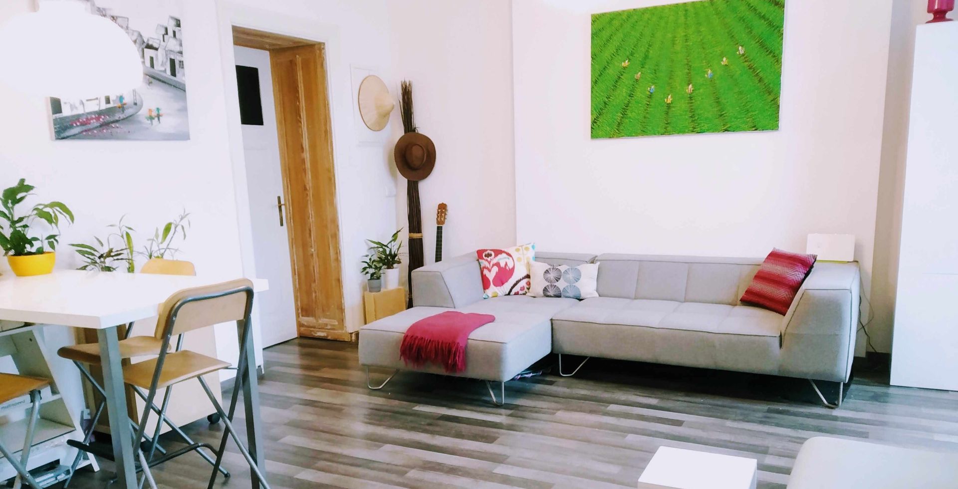Living room of our holiday apartment in Berlin with a couch , table and chairs.