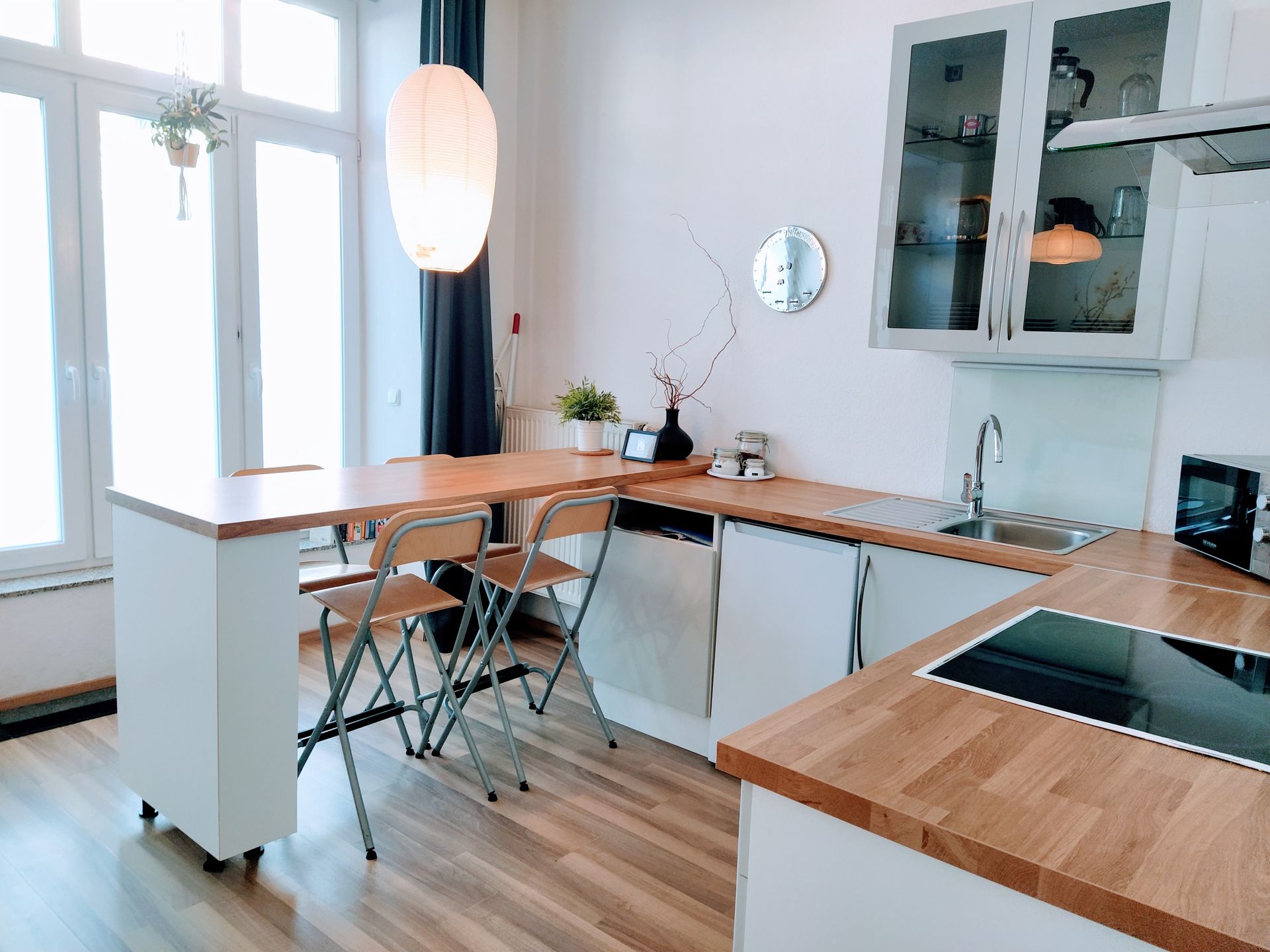 A kitchen with a table and chairs and a stove top oven in our Berlin vacation apartment.