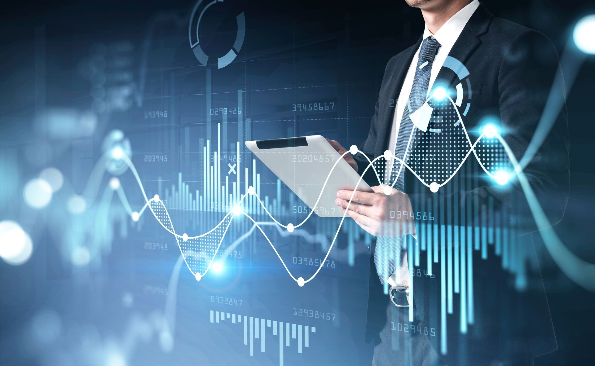 A man in a suit and tie is holding a clipboard with a graph on it.