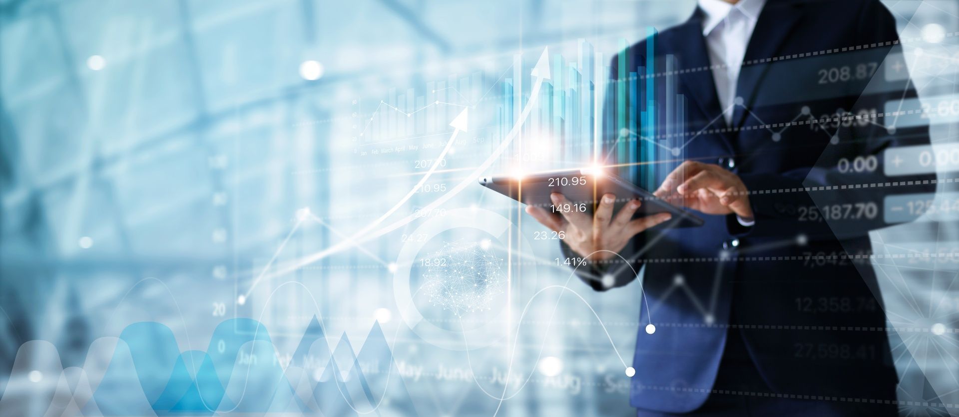 A man in a suit is using a tablet with a graph on it.