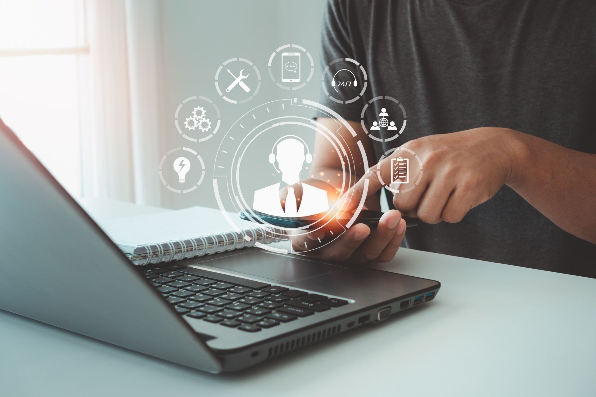 A man is holding a magnifying glass in front of a laptop computer.