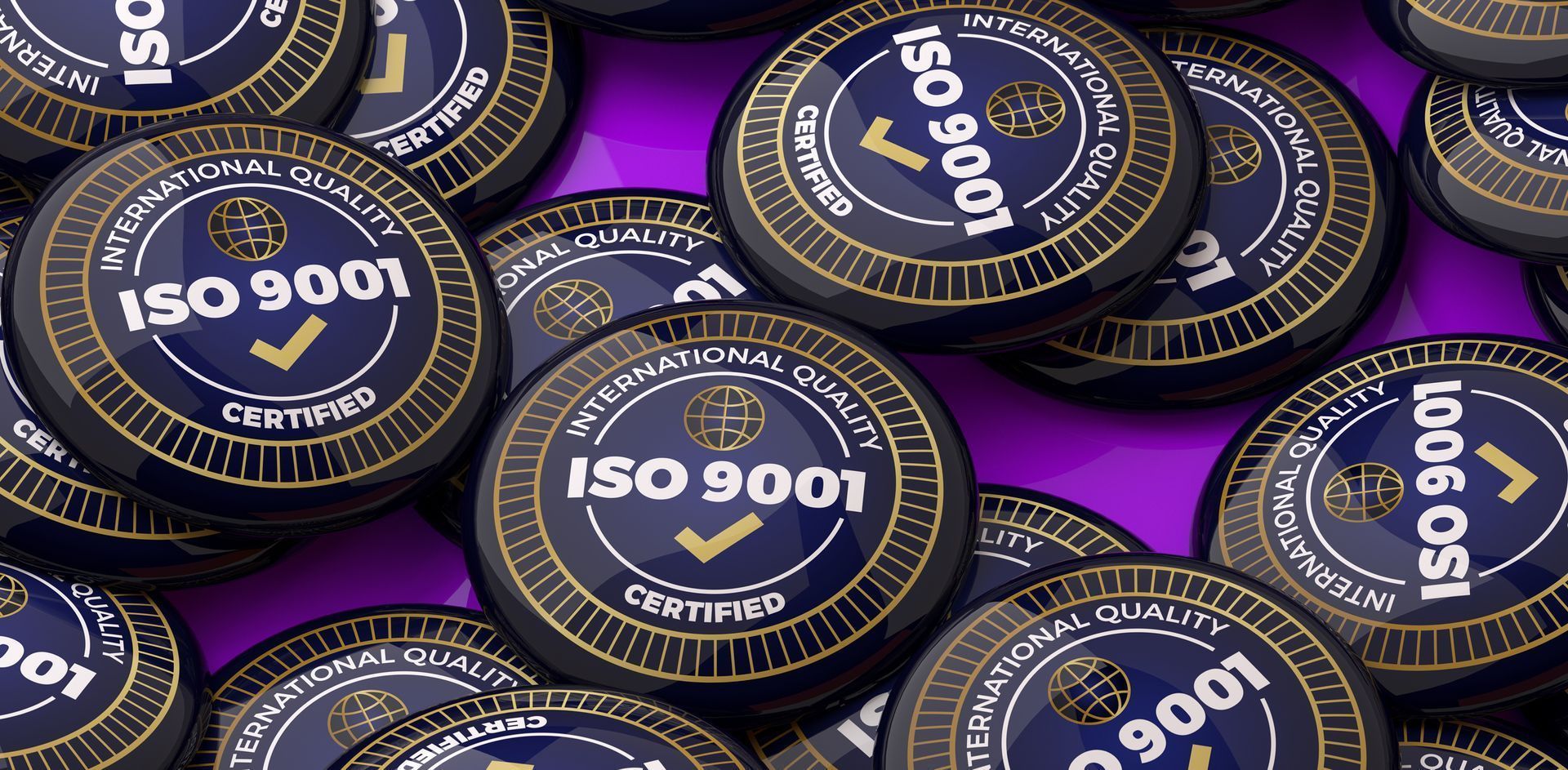 A pile of iso 9001 badges on a purple surface