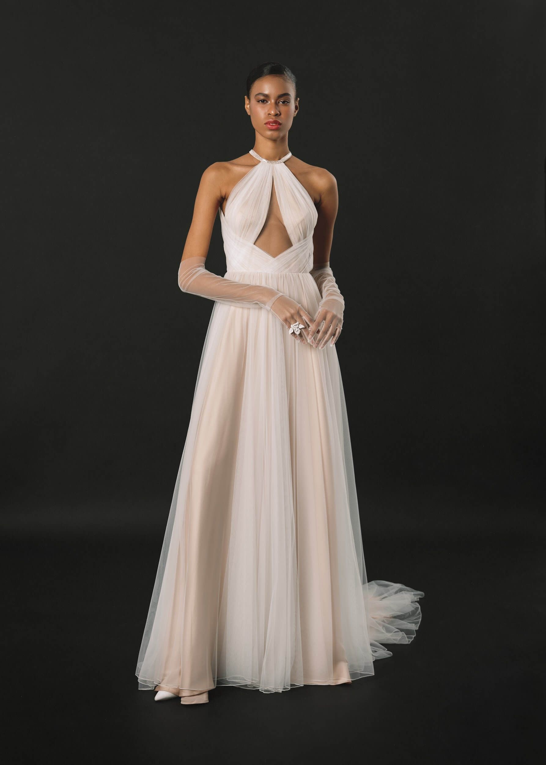 Eine Frau trägt ein weißes Brautkleid und Handschuhe.