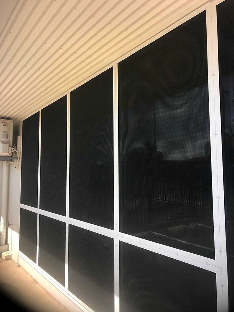 A Row Of Black Windows With Security Screens — Readycut Screens & Doors in Winnellie, NT