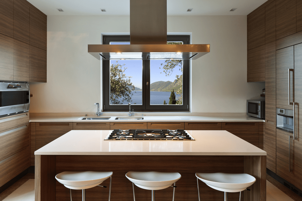 A Kitchen With A Large Island And A Stove Top Oven — Readycut Screens & Doors in Winnellie, NT