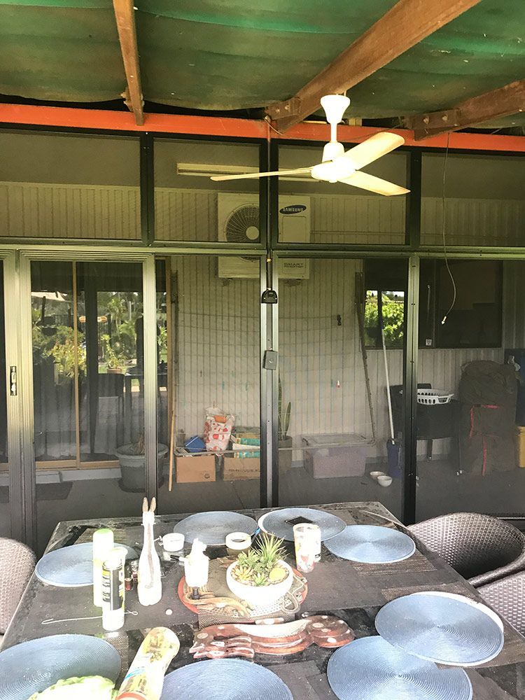 A Patio With A Table And Chairs And A Ceiling Fan — Readycut Screens & Doors in Palmerston, NT