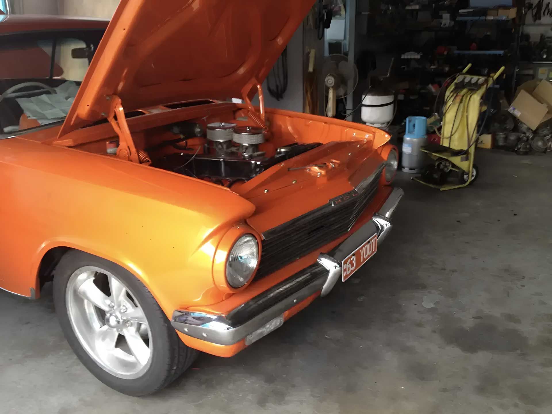 An Orange Car With The Hood Up Open — Barron River Auto Electrics & Air-conditioning in Stratford, QLD