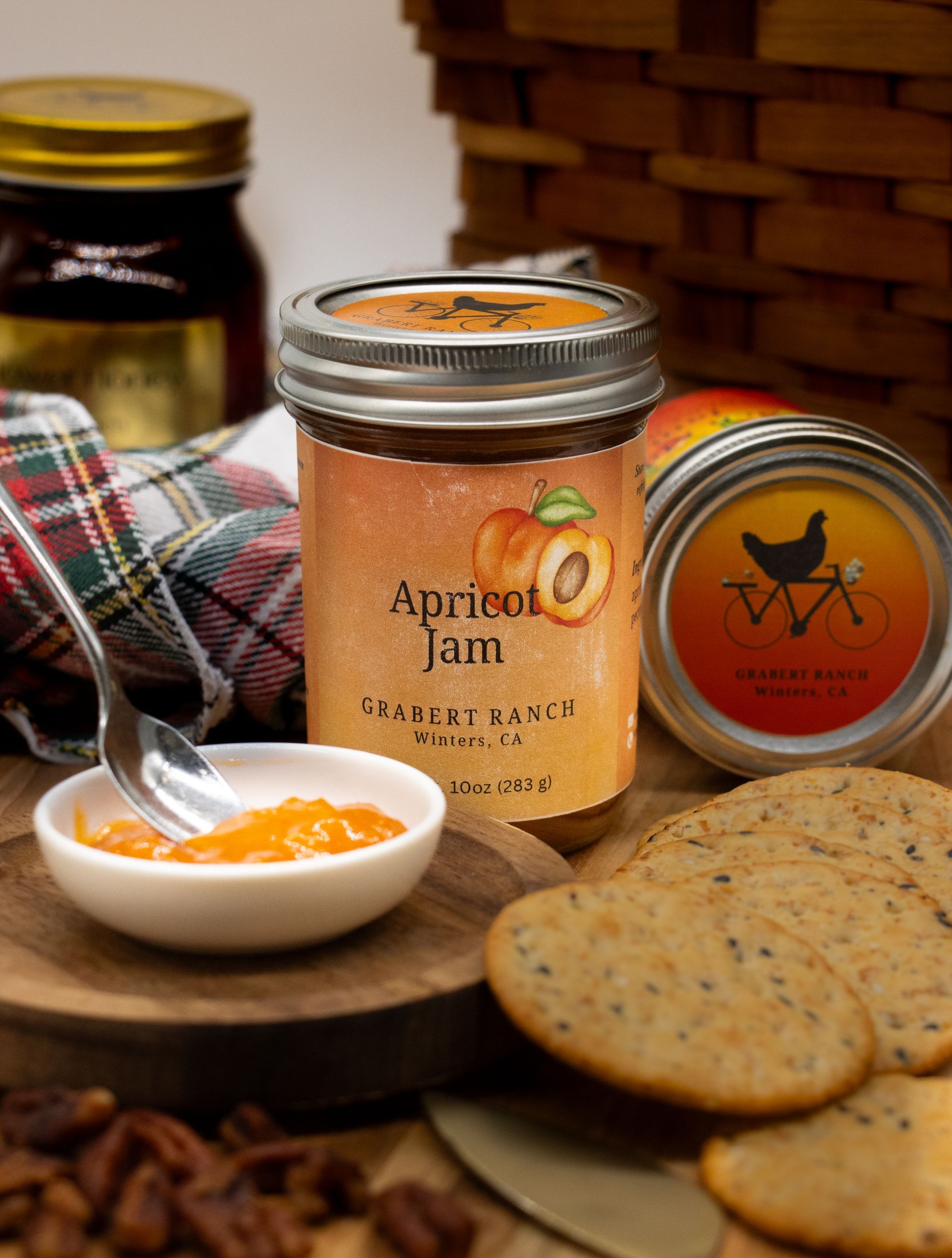 A jar of Grabert Ranch apricot jam with a label featuring an illustration of an apricot, centered on a white background.