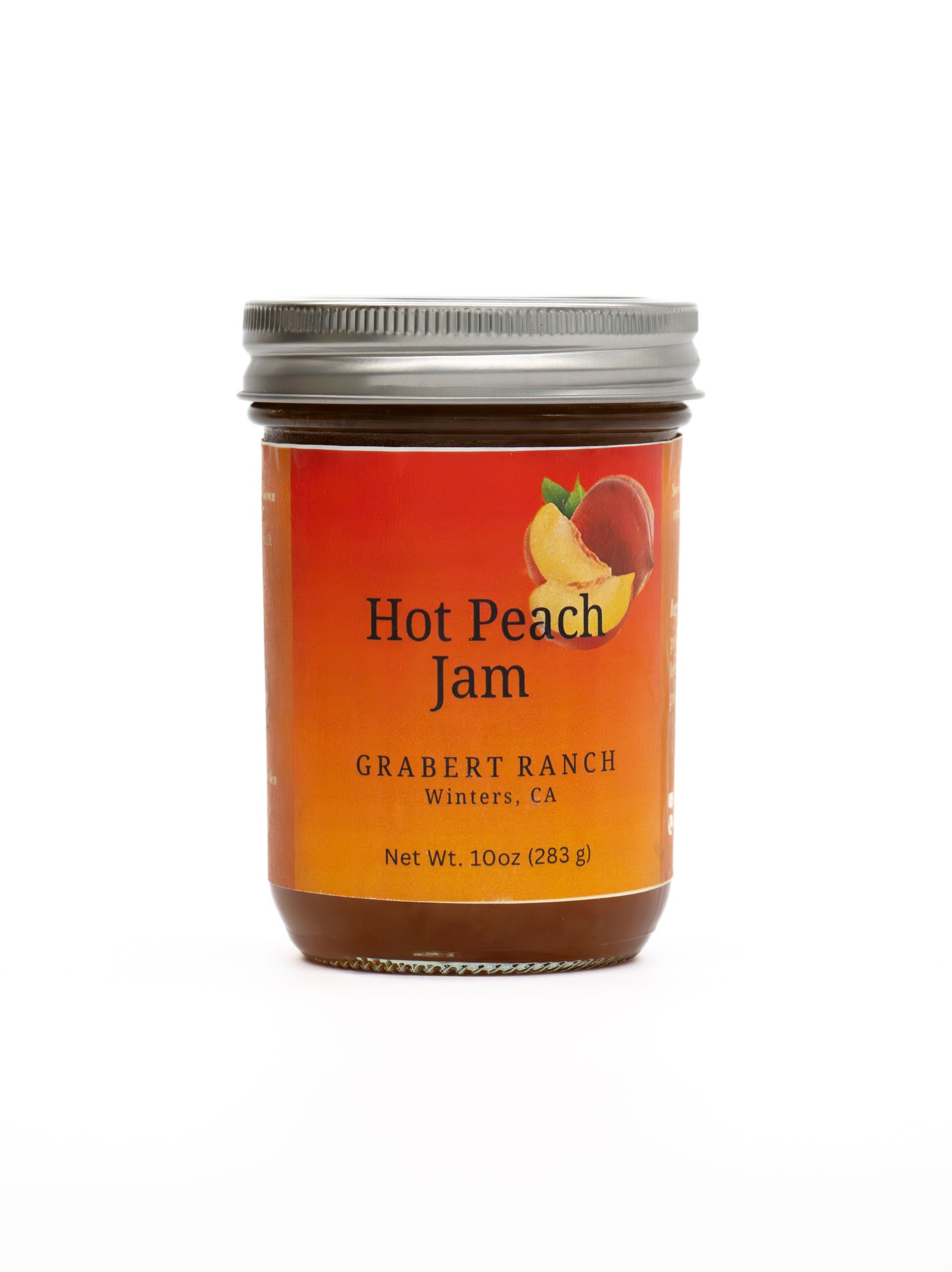 A jar of Hot Peach Jam with a silver lid and a bright orange label featuring a graphic of peaches.