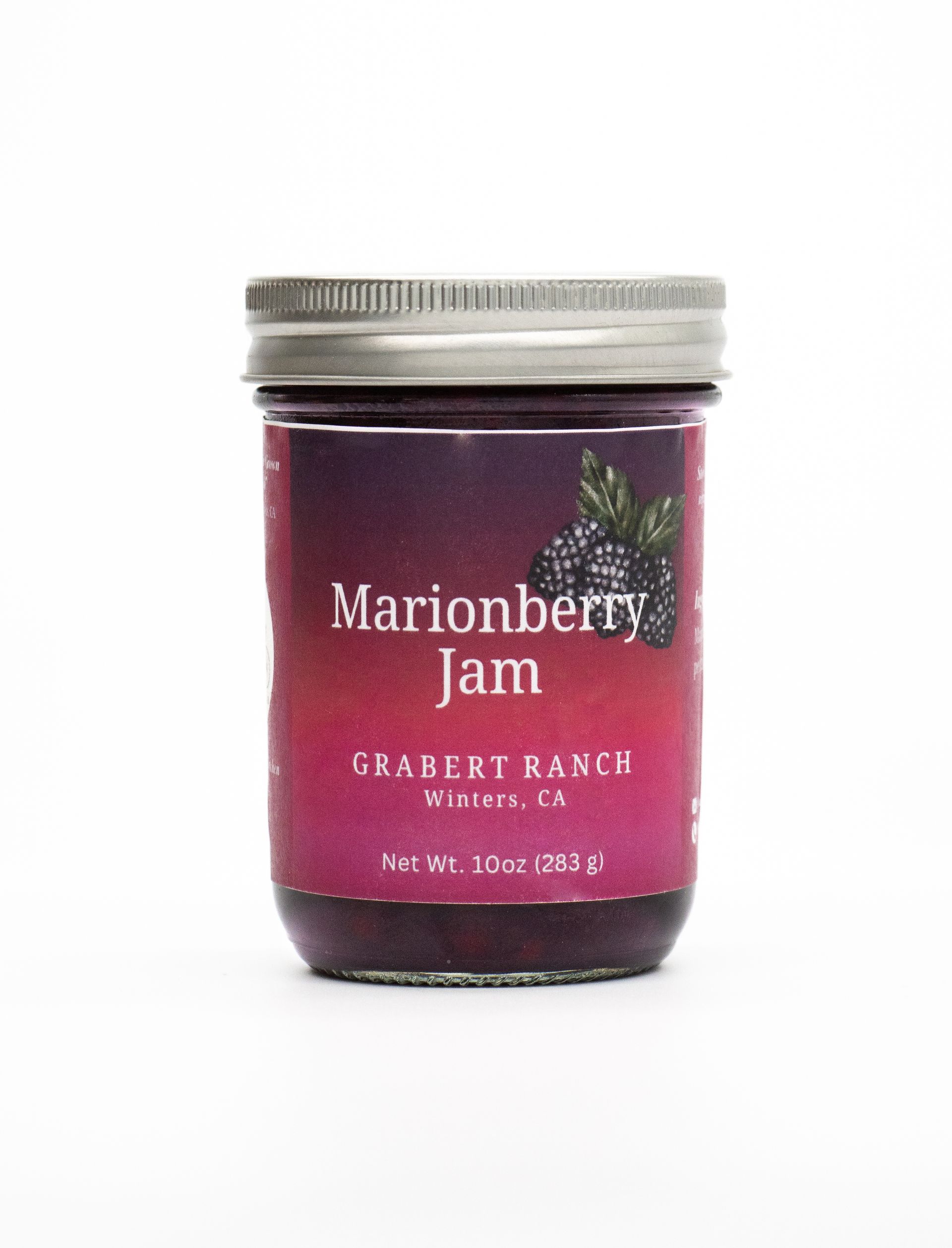 A glass jar of Grabert Ranch Marionberry Jam with a purple and pink label featuring a graphic of marionberries.