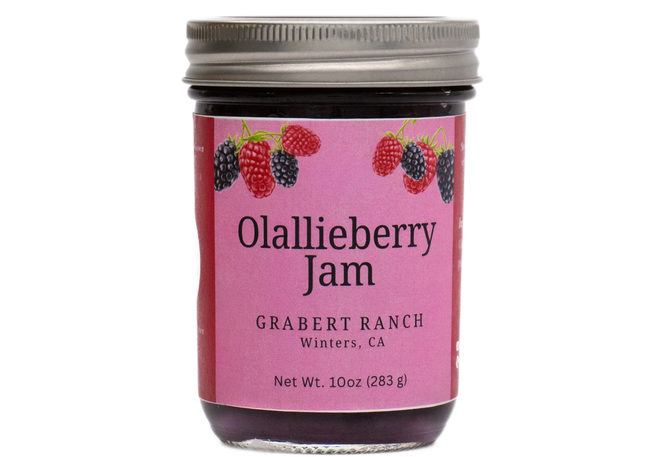 A jar of Grabert Ranch Olallieberry Sauce with a pink label featuring berry illustrations, against a white background.