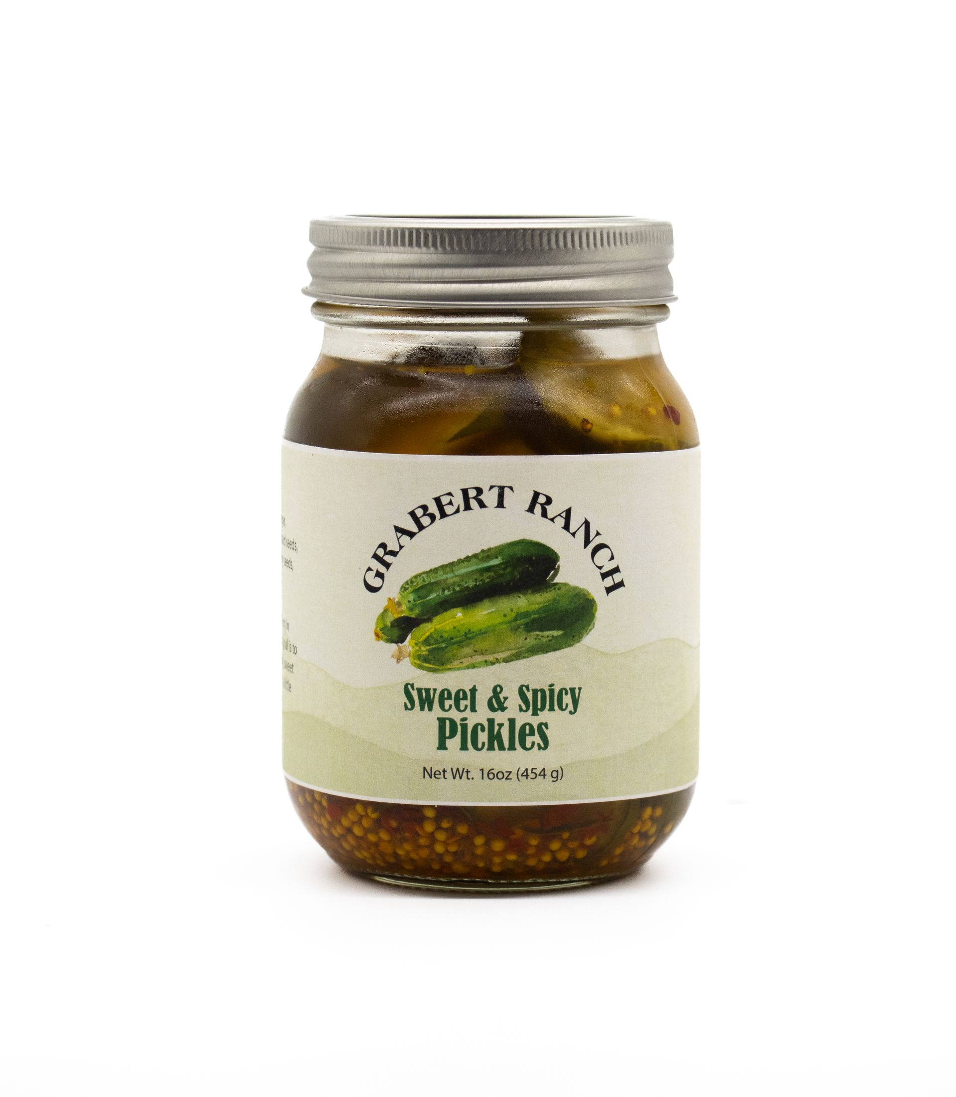 A glass jar of Grabert Ranch Sweet & Spicy Pickles with a cream-colored label featuring two cucumber illustrations.
