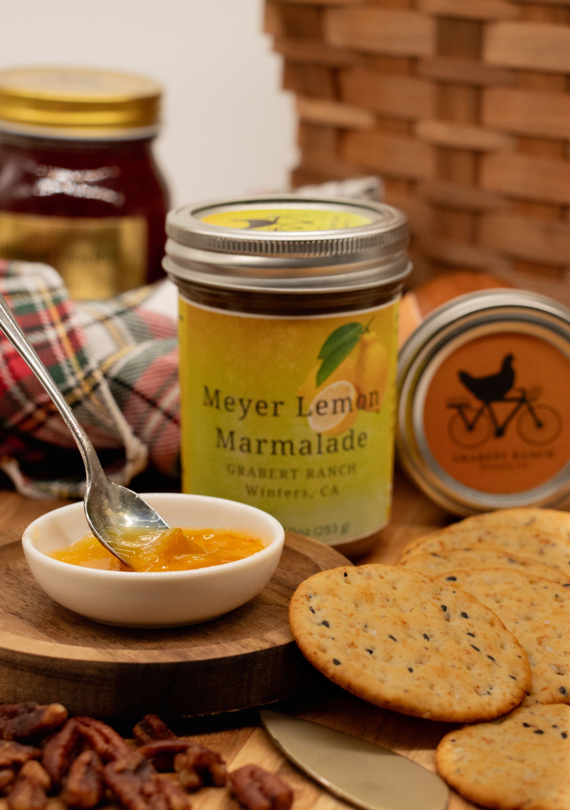 A jar of Meyer Lemon Marmalade from Chauce Ranch, Winters, CA, with a yellow label and silver lid on a white background.