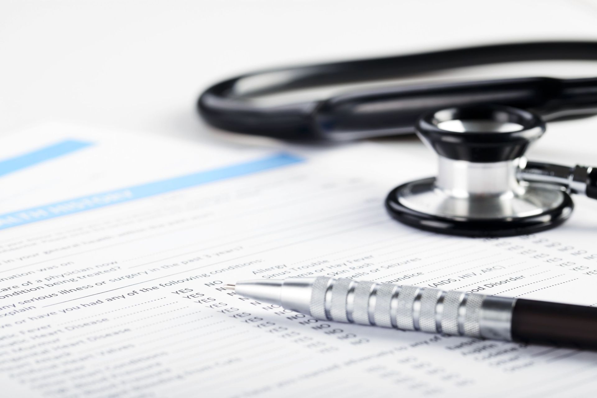 filling medical form document stethoscope