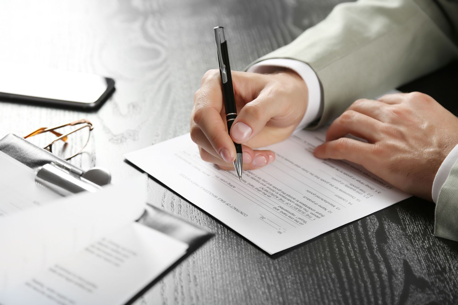 male hands pen signing document desk