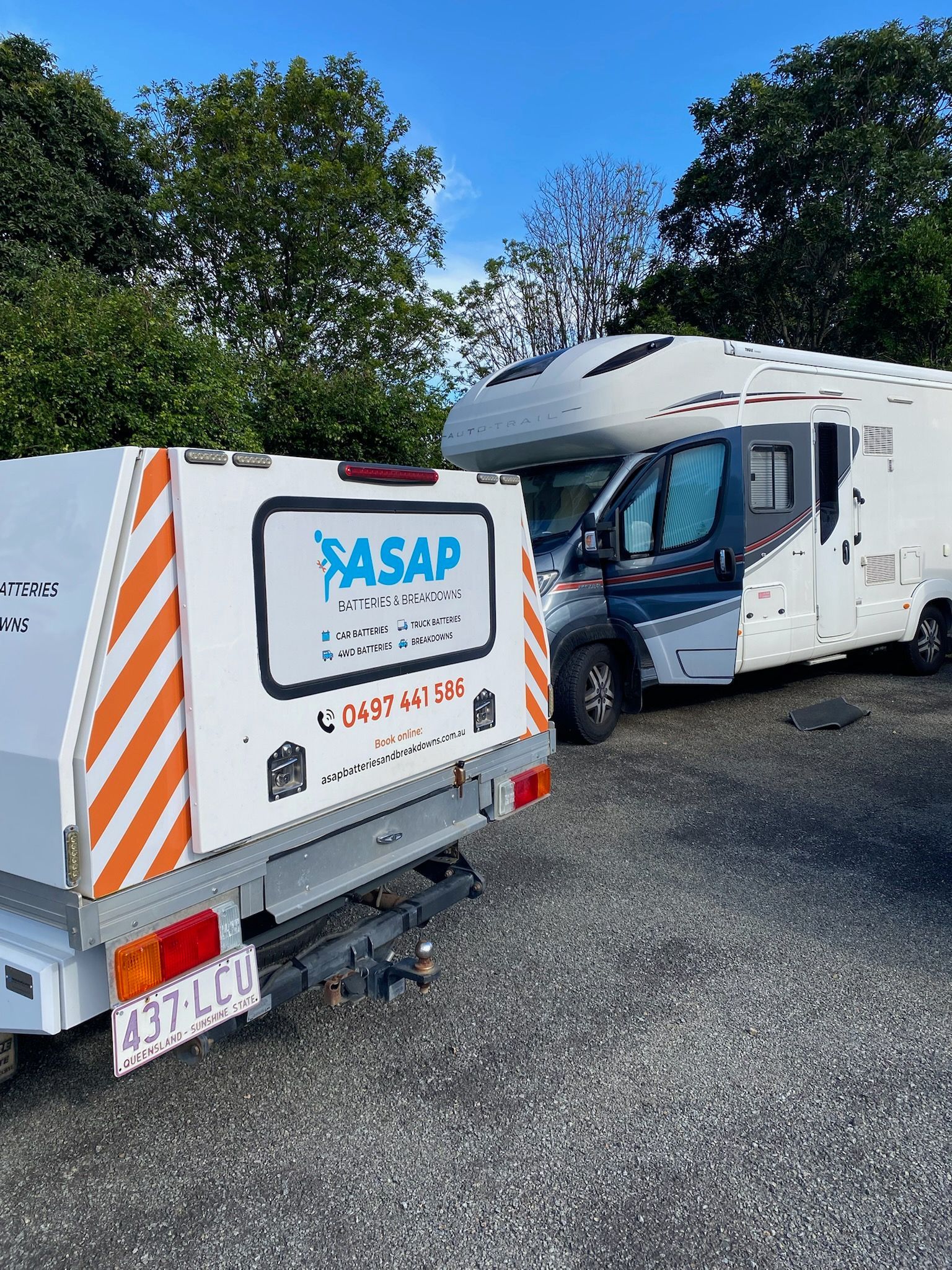 White Camper Trailer Attached to a White Utility Trailer With Orange Stripes — ASAP Batteries & Breakdowns in Helensvale, QLD